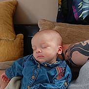 Zoé participe au concours pour gagner de l'argent avec cette photo : baby, sleeping, denim_shirt, tattoo, arm, cushion, blanket, sofa, indoor, peaceful, child, portrait, relaxing, comfort, closeup, person, casual_clothing, infant, resting, home