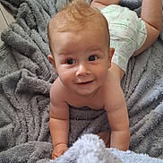 Henry joined the competition — help win amazing prizes! baby, infant, diaper, blanket, crawling, smile, face, skin, hair, child, cute, indoors, soft_texture, happy, playful, person, young, expression, floor, toddler