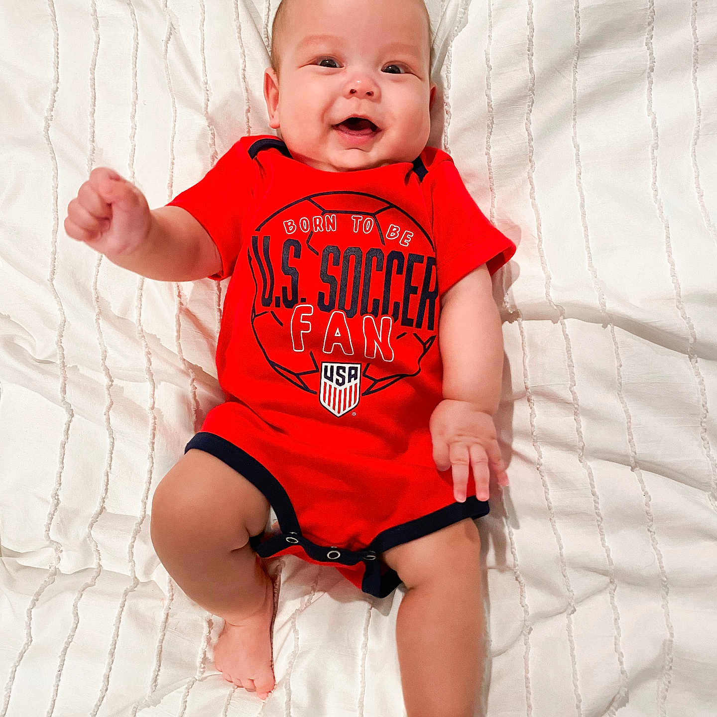 Bennett joined the competition — help win amazing prizes! baby, babylaughing, bodypart, clothing, face, finger, furniture, hand, happy, head, laughing, newborn, person, photography, portrait, shirt, shorts, sitting, smile, t_shirt