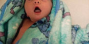 Sylvia joined the competition — help win amazing prizes! baby, blanket, blue, green, cartoon, face, infant, looking_up, open_mouth, wrapped, snug, soft, cute, child, newborn, expression, indoors, warm, cozy, portrait