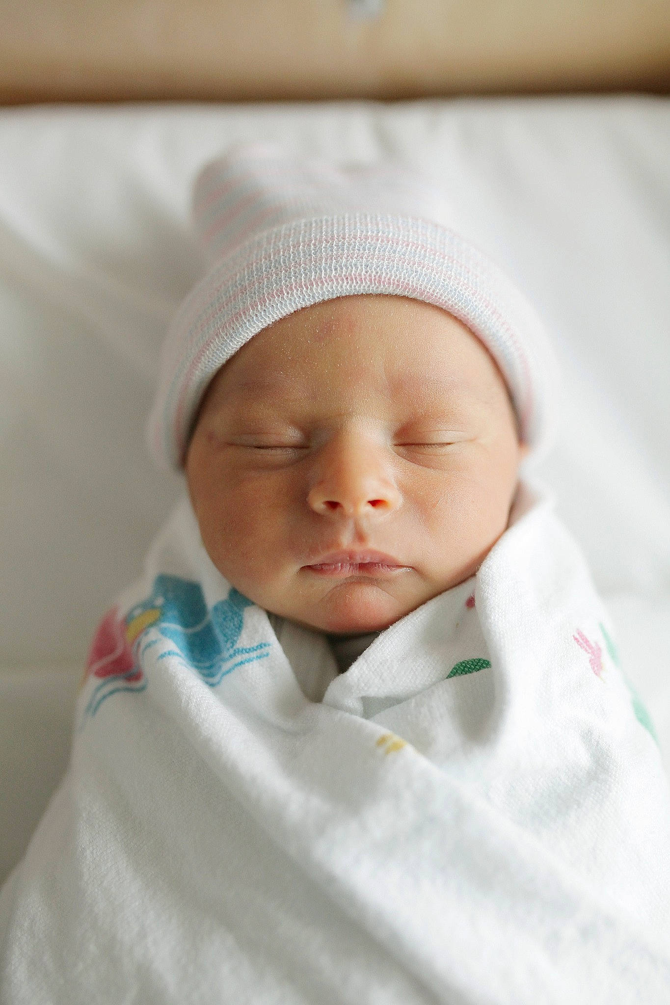 Carlos is registered to the contest to win money with this photo: baby, baby_sleeping, baby_toddler_clothing, child, collar, comfort, face, hat, linens, peach, person, portrait_photography, room, service, sleeve, toddler