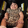 Gianna joined the competition — help win amazing prizes! baby, infant, car_seat, smile, black_bow, leopard_print, dress, white_shoes, chubby_arms, cute, child, happy, indoors, seatbelt, warning_label, skin, person, portrait, young_child, clothing