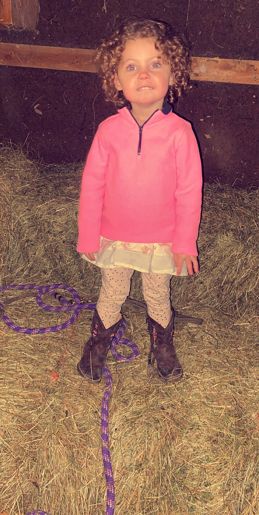 Montana is registered to the contest to win money with this photo: baby_toddler_clothing, child, dress, electric_blue, face, footwear, grass, human_leg, knee, leg, magenta, people_in_nature, person, personal_protective_equipment, pink, sleeve, sock, soil, tints_and_shades, toddler