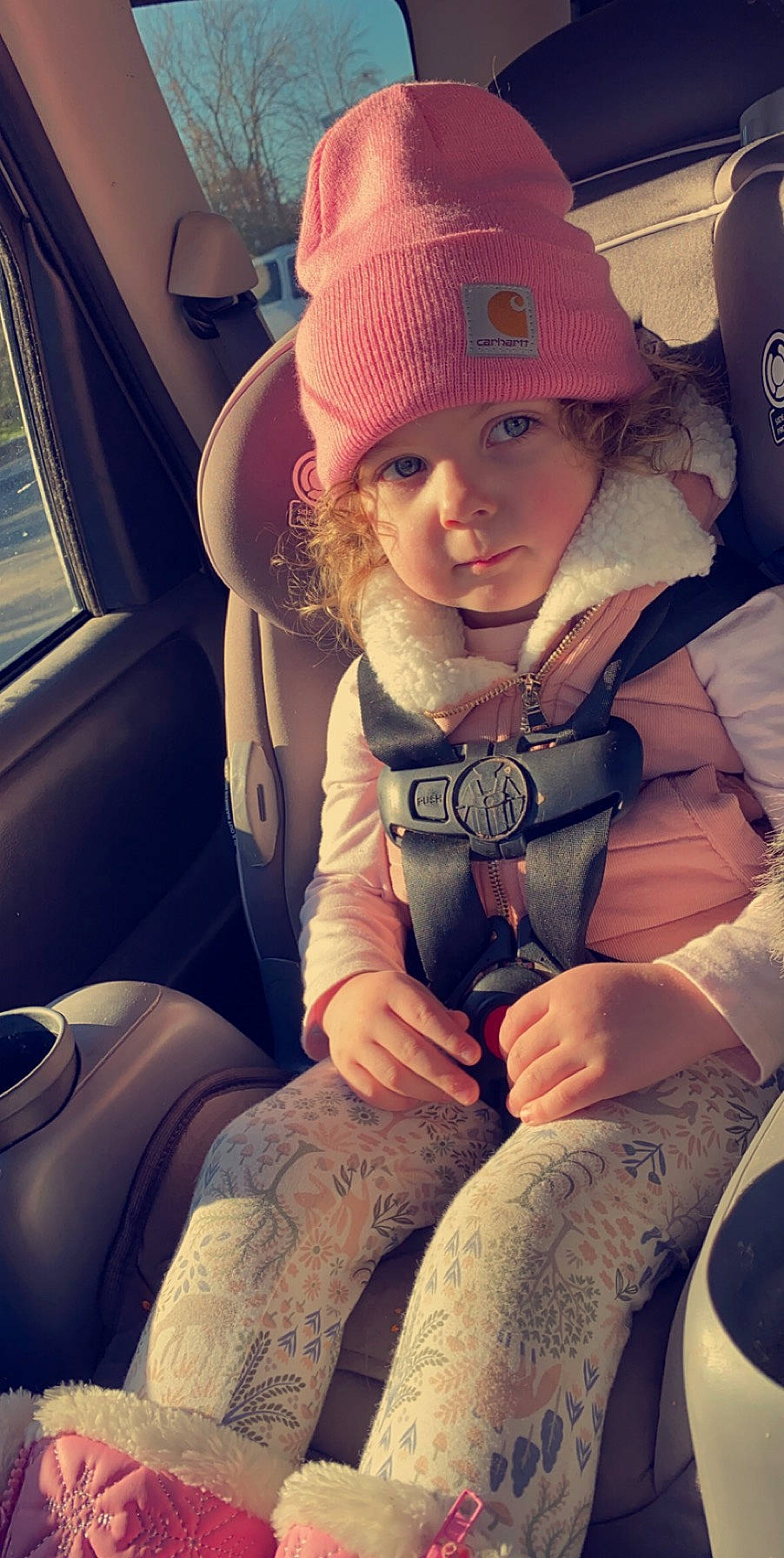 Montana is registered to the contest to win money with this photo: arm, baby, beauty, cap, car, car_seat, comfort, cool, finger, hairstyle, hand, happy, headwear, human, lap, light, person, seat_belt, thigh, tints_and_shades