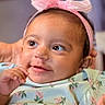 Zahrah is registered to the contest to win money with this photo: baby, infant, child, portrait, face, smiling, happy, pink_bow, headband, floral_dress, clothing, indoor, close_up, sitting, hand, eyes, looking_at_camera, caregiver, soft_lighting, adorable