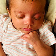 Zahrah is registered to the contest to win money with this photo: newborn, baby, infant, sleeping, portrait, face, closed_eyes, striped_shirt, onesie, hand, fingers, hair, eyelashes, lips, cuddled, peaceful, indoors, blanket, close_up, photography