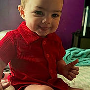 Jonah joined the competition — help win amazing prizes! baby, child, toddler, red_shirt, thumbs_up, smile, face, sitting, indoors, bed, blanket, purple_wall, person, cute, happy, young_child, skin, short_hair, buttoned_shirt, expression