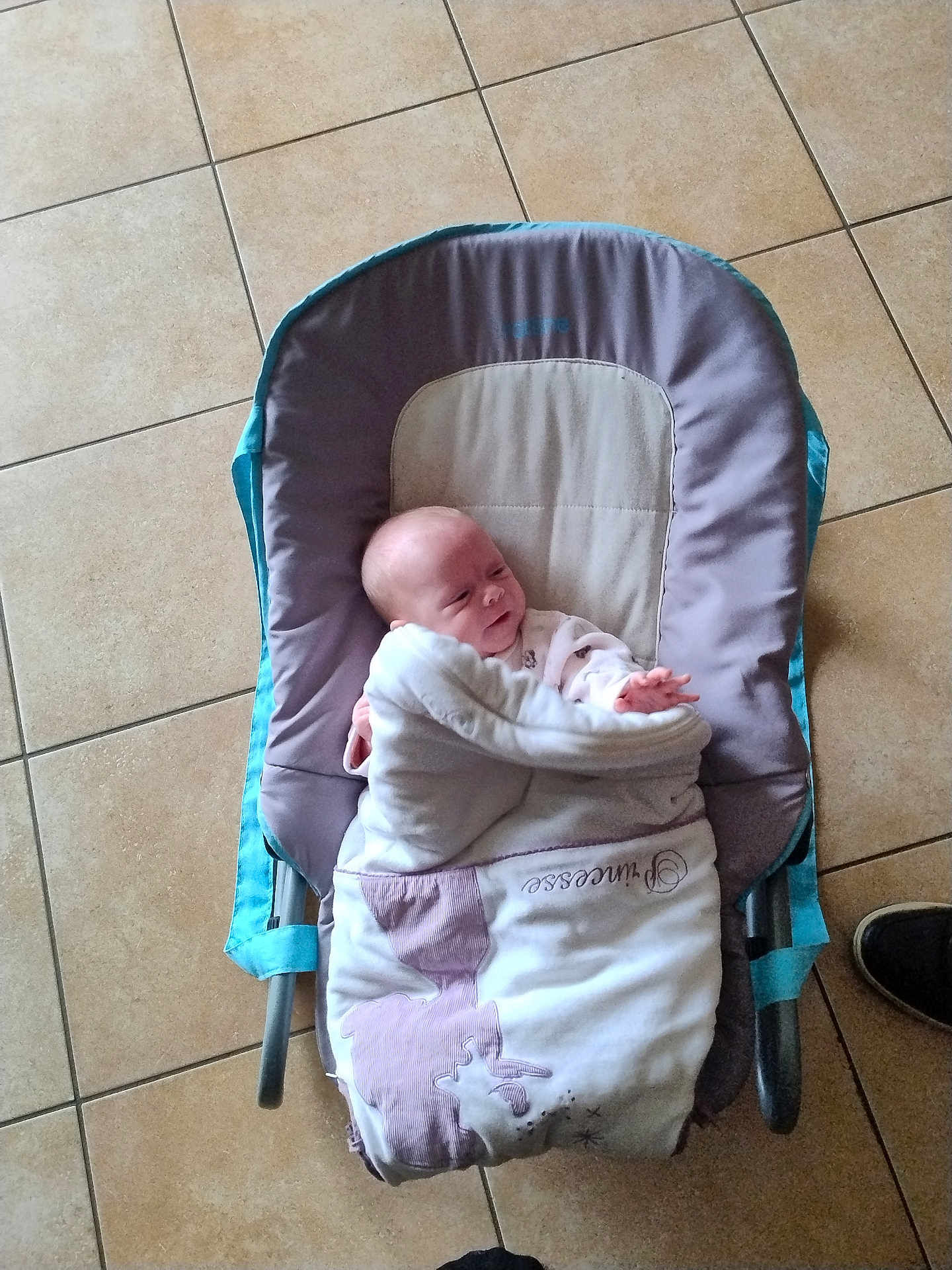 Tiffany participe au concours pour gagner de l'argent avec cette photo : baby, blanket, baby_chair, floor, tiled_floor, infant, child, cushion, indoor, resting, reaching_hand, soft_fabric, comfort, small_hand, person, portrait, relaxed, cute, wrapped, seated