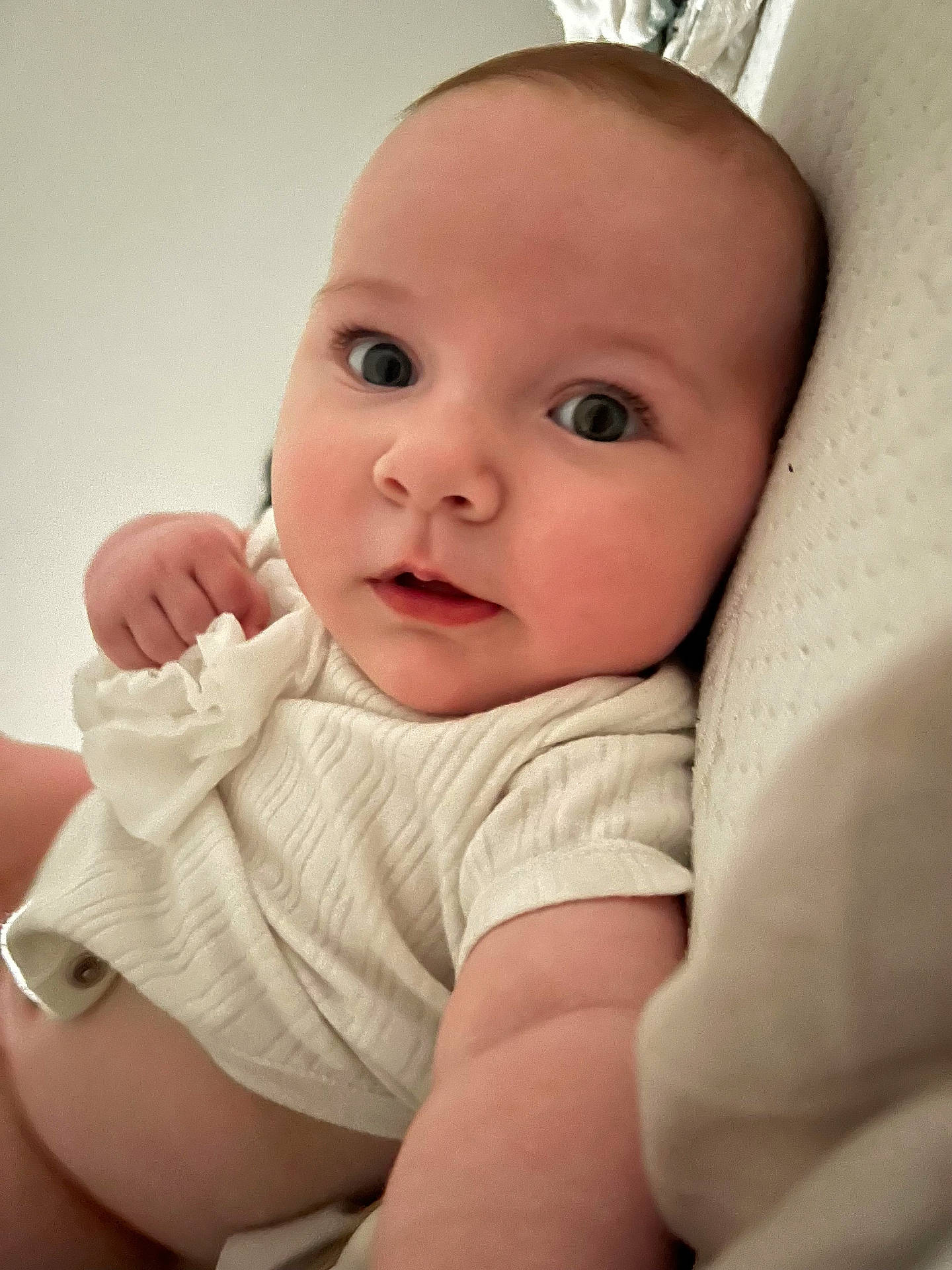 Arabella is registered to the contest to win money with this photo: baby, bodypart, bonnet, clothing, couch, diaper, face, finger, furniture, hand, happy, hat, head, knitwear, newborn, person, photography, portrait, smile, sweater