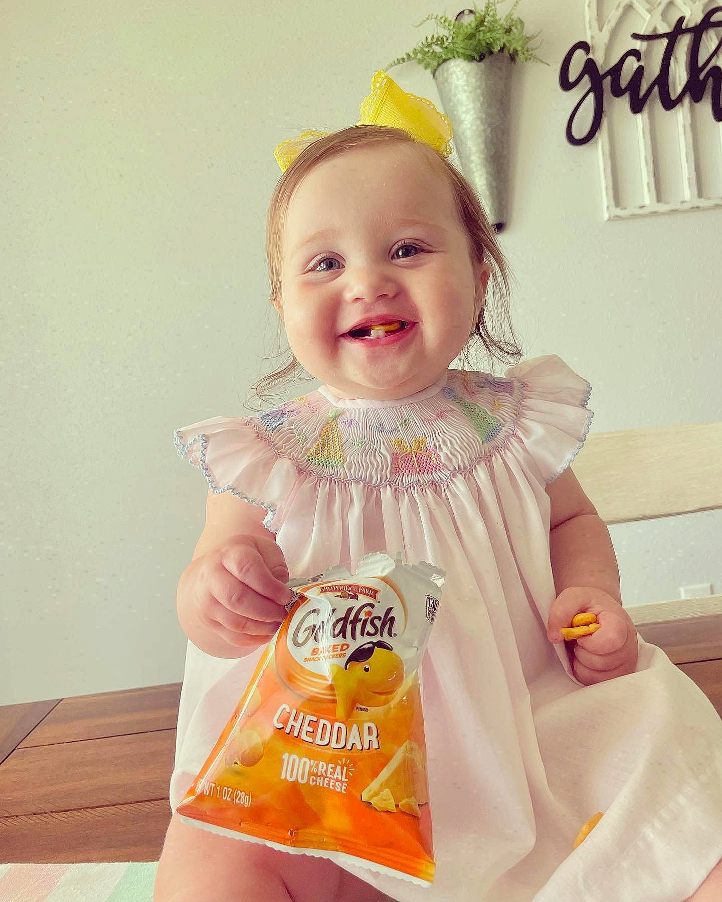 Gracie is registered to the contest to win money with this photo: baby, baby_products, baby_toddler_clothing, blond, child, dress, fashion_accessory, fun, hairstyle, happy, jewellery, joy, pattern, peach, person, skin, sleeve, sleeveless_shirt, smile, t_shirt
