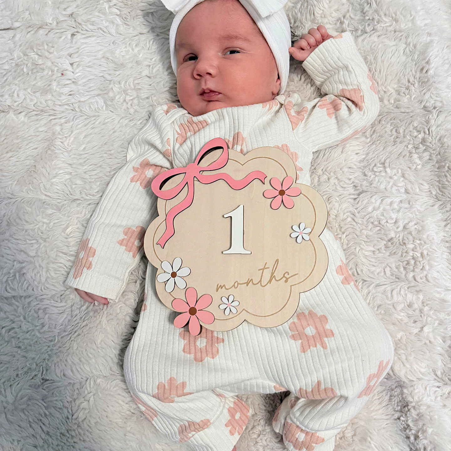 Kennedy is registered to the contest to win money with this photo: baby, blanket, bow, cozy, cute, feet, floral_pattern, hand, headband, indoors, infant, lying_down, milestone, newborn, one_month, pink_flowers, portrait, soft_texture, white_clothing, wooden_sign