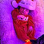 baby, sleeping, christmas_hat, red_clothing, plush_blanket, holiday, festive, infant, soft_texture, purple_lighting, cozy, cute, newborn, celebration, christmas, holiday_lights, sleep, indoors, child, festive_outfit