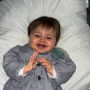 Zayn a rejoint le concours — aidez-le/la à gagner de superbes lots ! baby, infant, child, pillow, striped_pajamas, smiling, hands, pacifier, sofa, remote_control, hair, face, teeth, happy, indoor, drooling, clapping, portrait, clothing, cushion