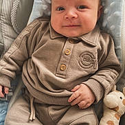 Kairo is registered to the contest to win money with this photo: baby, infant, child, plush_toy, giraffe_toy, socks, clothing, beige_outfit, baby_seat, smile, face, hand, cute, soft_texture, cozy, indoor, portrait, comfort, small_scratches, relaxed