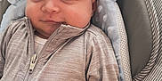 Kairo joined the competition — help win amazing prizes! baby, infant, child, face, smile, clothing, zipper, soft_toys, cushion, baby_seat, gray_shirt, striped_pattern, cute, indoors, portrait, closeup, comfort, happy, young, relaxed