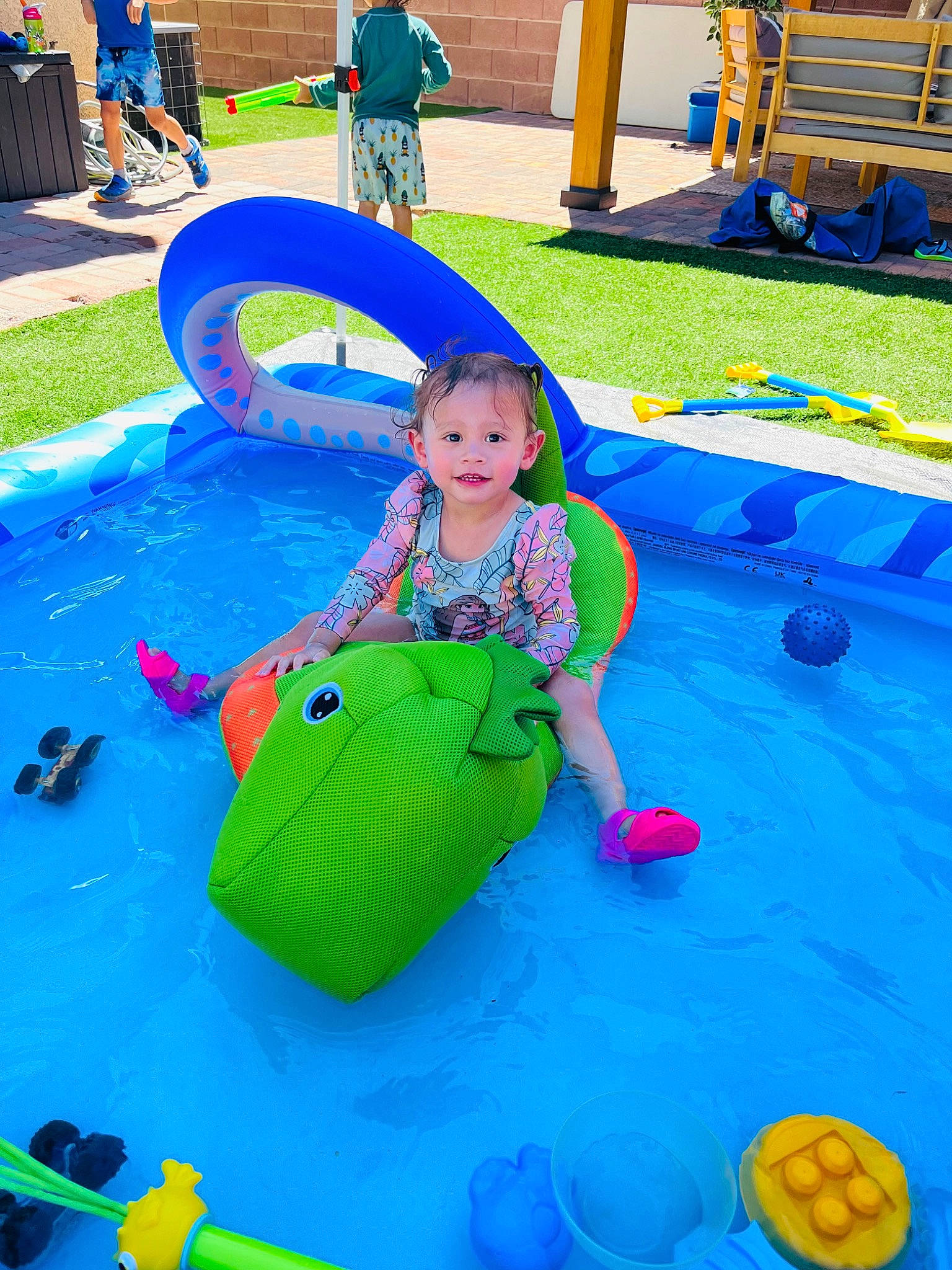 Kaislee joined the competition — help win amazing prizes! baby, baby_products, baby_toddler_clothing, baby_toys, blue, child, fun, games, grass, green, inflatable, joy, leisure, outdoor_play_equipment, person, play, playground, recreation, sitting, toddler