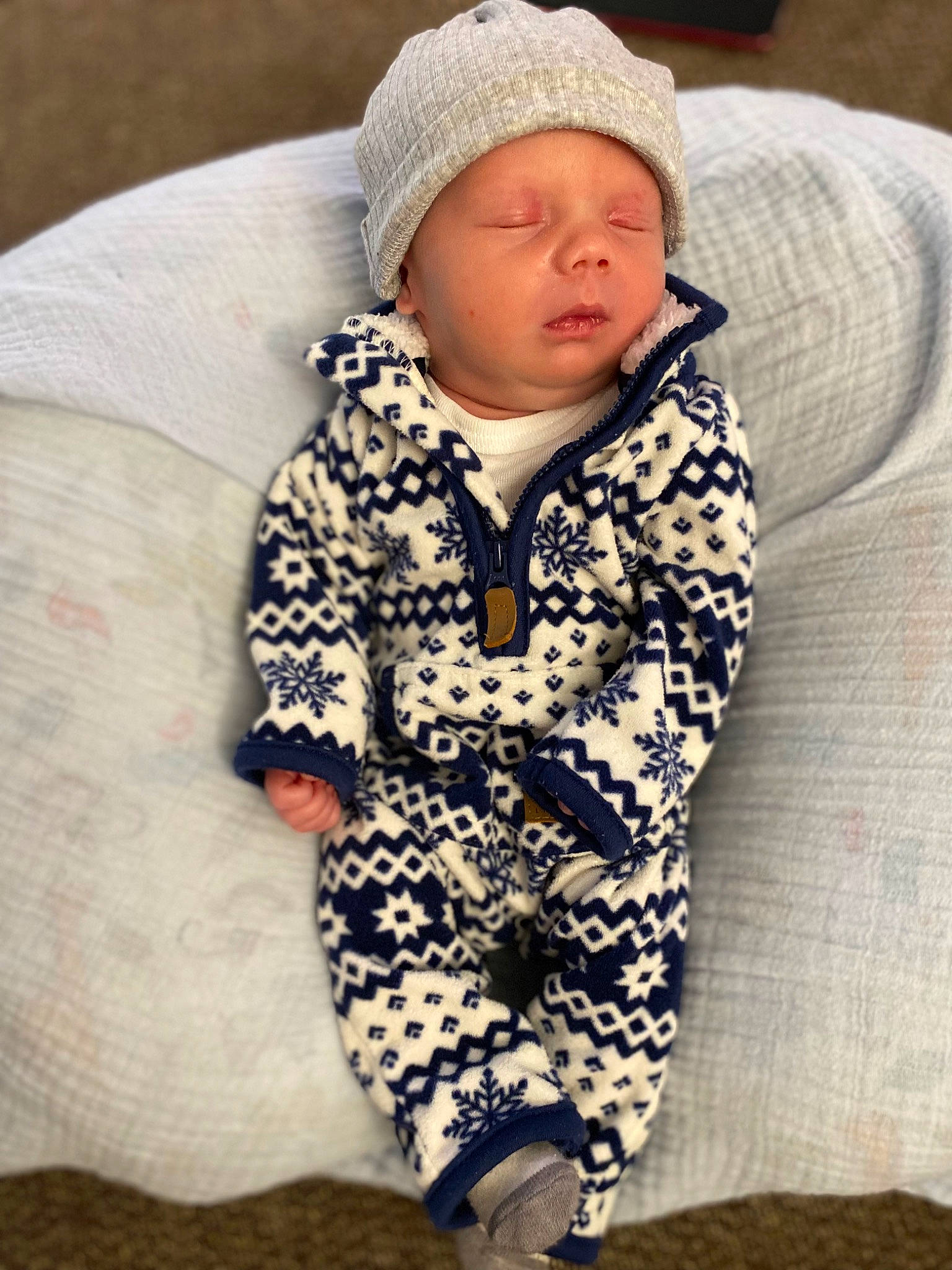Kolten is registered to the contest to win money with this photo: baby, baby_sleeping, baby_toddler_clothing, cap, cheek, child, collar, comfort, cool, eye, face, head, headwear, hood, jacket, outerwear, pattern, person, sitting, skin