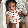 Jasai joined the competition — help win amazing prizes! baby, infant, child, onesie, clothing, face, hair, curly_hair, baby_seat, cushion, indoor, portrait, cute, skin, hand, leg, floor, expression, looking, relaxed