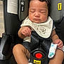 baby, sleeping, car_seat, infant, bib, sock, child, straps, safety, peaceful, cute, hand, clothing, fabric, indoors, rest, head, face, newborn, comfort