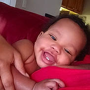 Nylah joined the competition — help win amazing prizes! baby, child, smiling, happy, indoor, face, skin, hand, cuddle, red, person, infant, expression, closeup, mouth, teeth, cute, joy, human, portrait