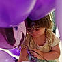 Evelyn is registered to the contest to win money with this photo: balloons, candid, celebration, child, closeup, curious, dress, face, fun, hair, hands, indoor, party, person, playful, purple, soft_light, strings, toddler, young_child