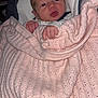 baby, newborn, blanket, pink, knitted, infant, face, hand, cushion, seat, red_eye, wrapped, cozy, portrait, child, indoor, clothing, sleepy, cute, small