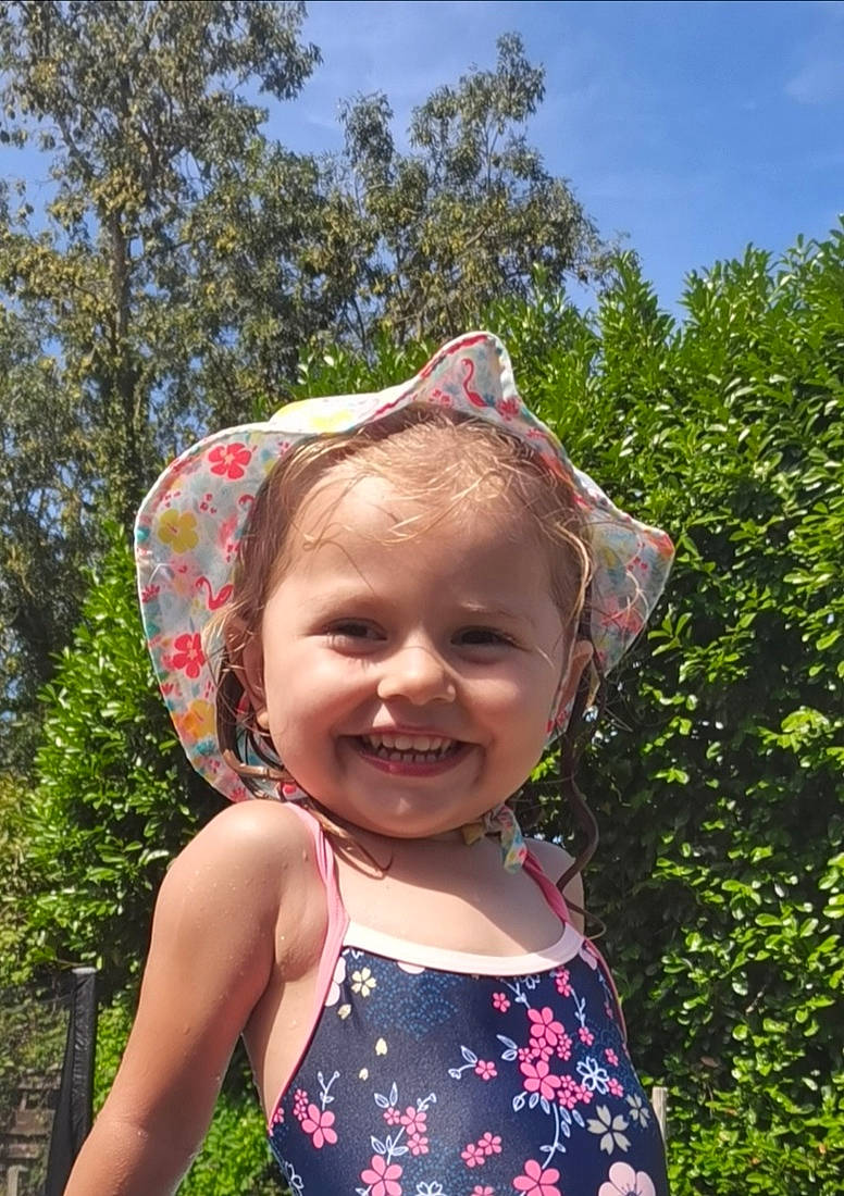 Clarisse participe au concours pour gagner de l'argent avec cette photo : botany, electric_blue, eyewear, fun, grass, happy, hat, headgear, joy, leaf, leisure, magenta, people_in_nature, person, pink, recreation, sky, smile, summer, sun_hat