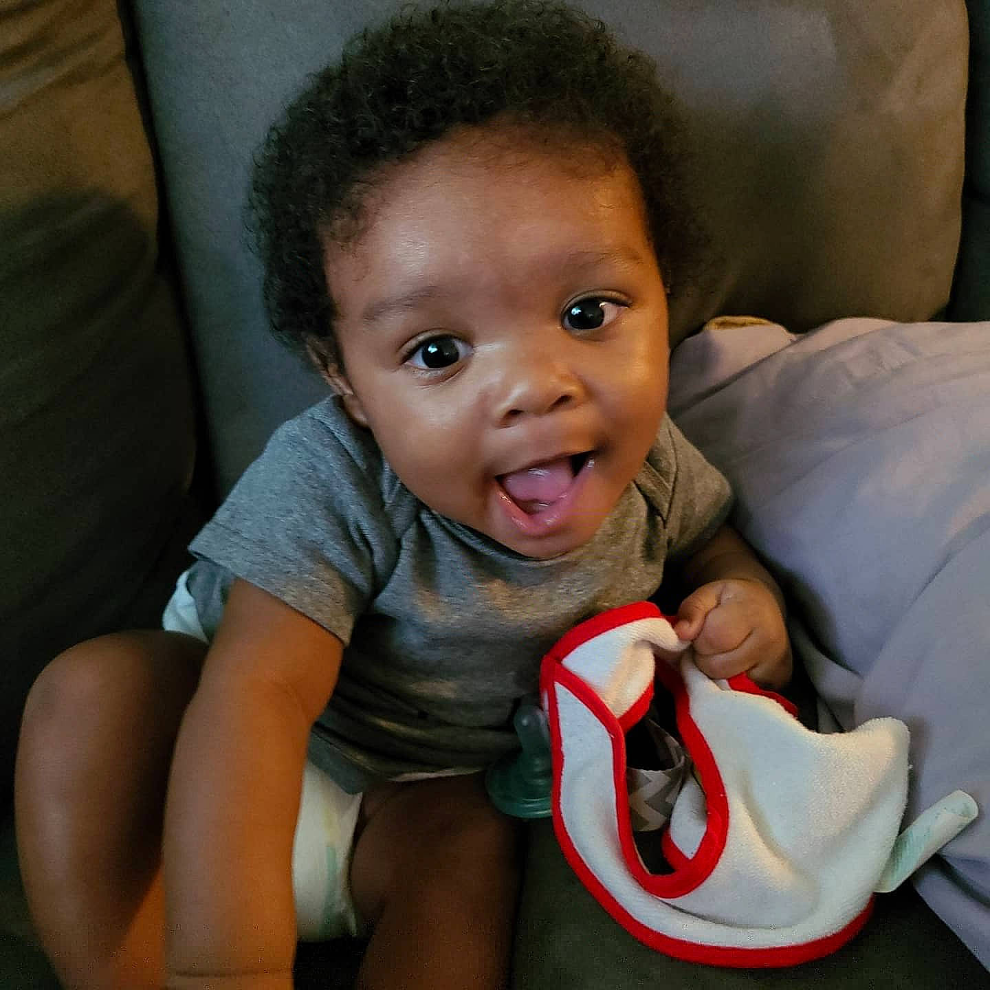 Jamal is registered to the contest to win money with this photo: baby, cheek, child, chin, eye, face, facial_expression, finger, fun, happy, head, laugh, lip, mouth, nose, person, sitting, skin, smile, toddler