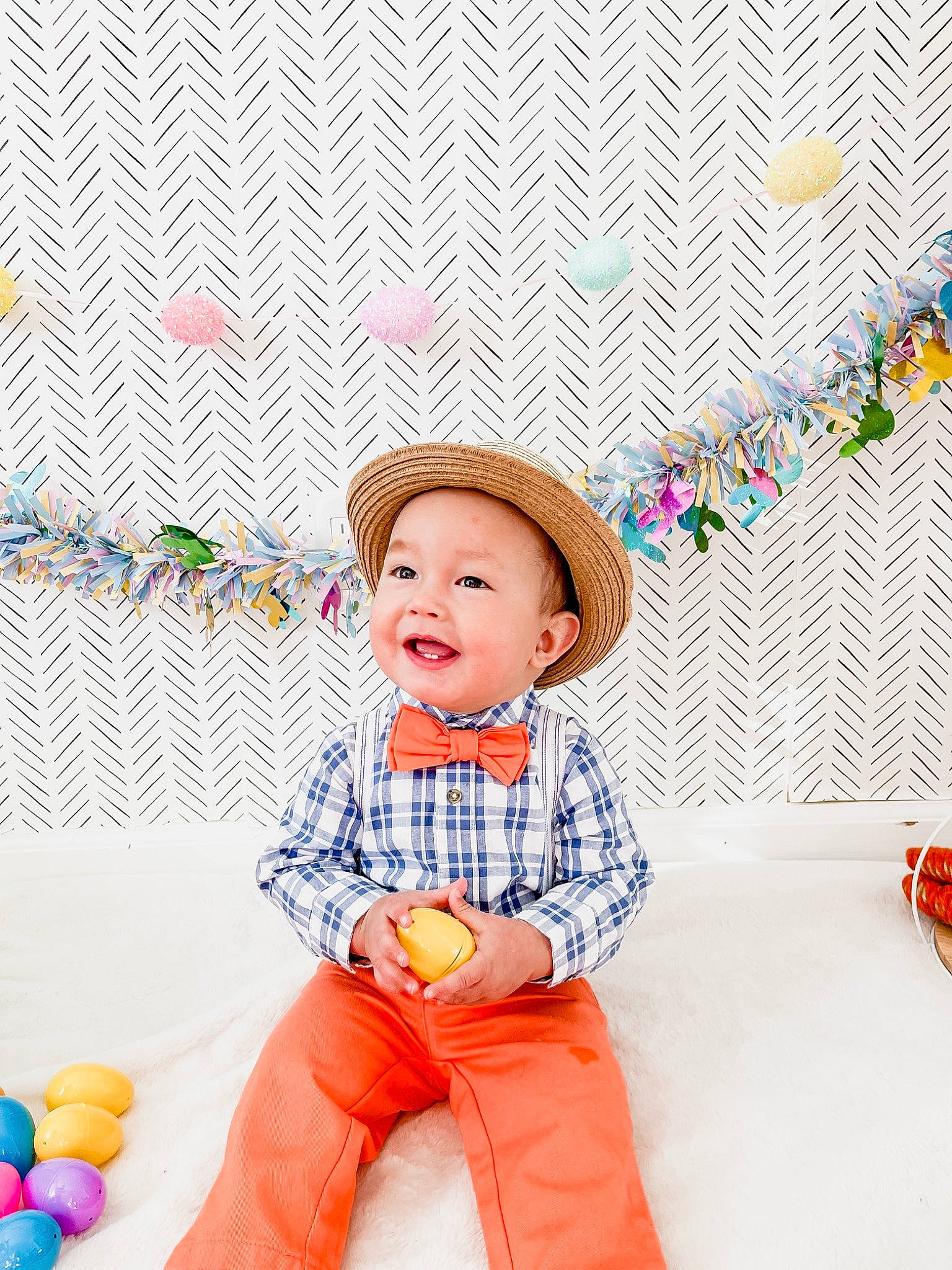 Miles joined the competition — help win amazing prizes! baby, baby_playing_with_toys, baby_toddler_clothing, child, costume_hat, facial_expression, fun, happy, hat, headgear, headwear, leisure, orange, party_supply, pattern, person, playing_with_kids, sitting, sleeve, smile