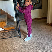 Tayana Grier joined the competition — help win amazing prizes! child, girl, indoor, carpet, stairs, braids, purple_tracksuit, white_shoes, metal_rack, wall_art, curious, standing, floor, home, bright_eyes, hair_beads, casual_clothing, young_child, portrait, room