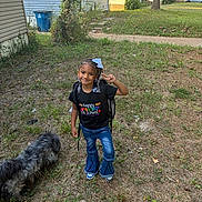 Donna joined the competition — help win amazing prizes! child, girl, smiling, outdoor, school, backpack, bow, braids, jeans, shoes, dog, pet, yard, grass, neighborhood, houses, sidewalk, sunny, portrait, first_day_of_school
