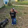 child, girl, smiling, outdoor, school, backpack, bow, braids, jeans, shoes, dog, pet, yard, grass, neighborhood, houses, sidewalk, sunny, portrait, first_day_of_school