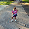 Donna joined the competition — help win amazing prizes! child, street, pose, purple_shirt, shorts, sneakers, backpack, sidewalk, shadow, tree, grass, residential_area, house, car, sunlight, afternoon, playful, outdoor, person, phone