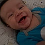 Malik joined the competition — help win amazing prizes! baby, smiling, infant, blue_clothing, face, happy, lying_down, patterned_sheet, animal_prints, cute, child, person, indoors, close_up, young_child, skin, head, eyes, mouth, cheeks