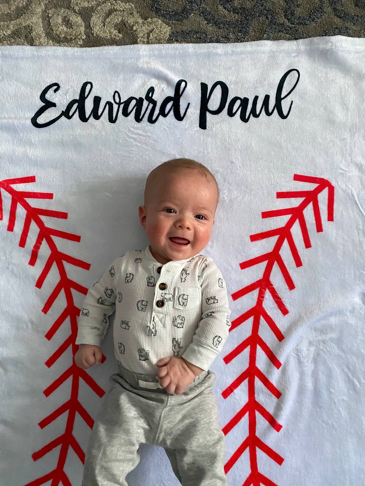 Eddie is registered to the contest to win money with this photo: art, baby, baby_toddler_clothing, child, design, font, happy, illustration, linens, logo, pattern, person, photograph, product, rectangle, sleeve, smile, style, t_shirt, toddler