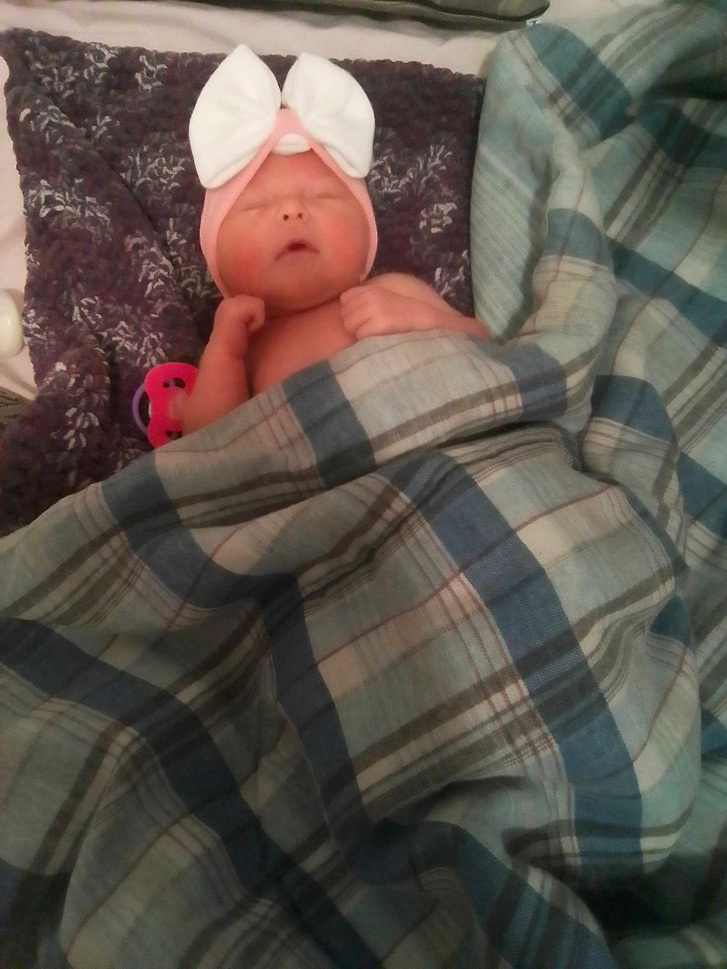 Rosie is registered to the contest to win money with this photo: baby, blanket, bow, child, cozy, cute, face, fist, headband, indoor, infant, knit, newborn, pink, plaid, purple, resting, sleeping, soft, toddler