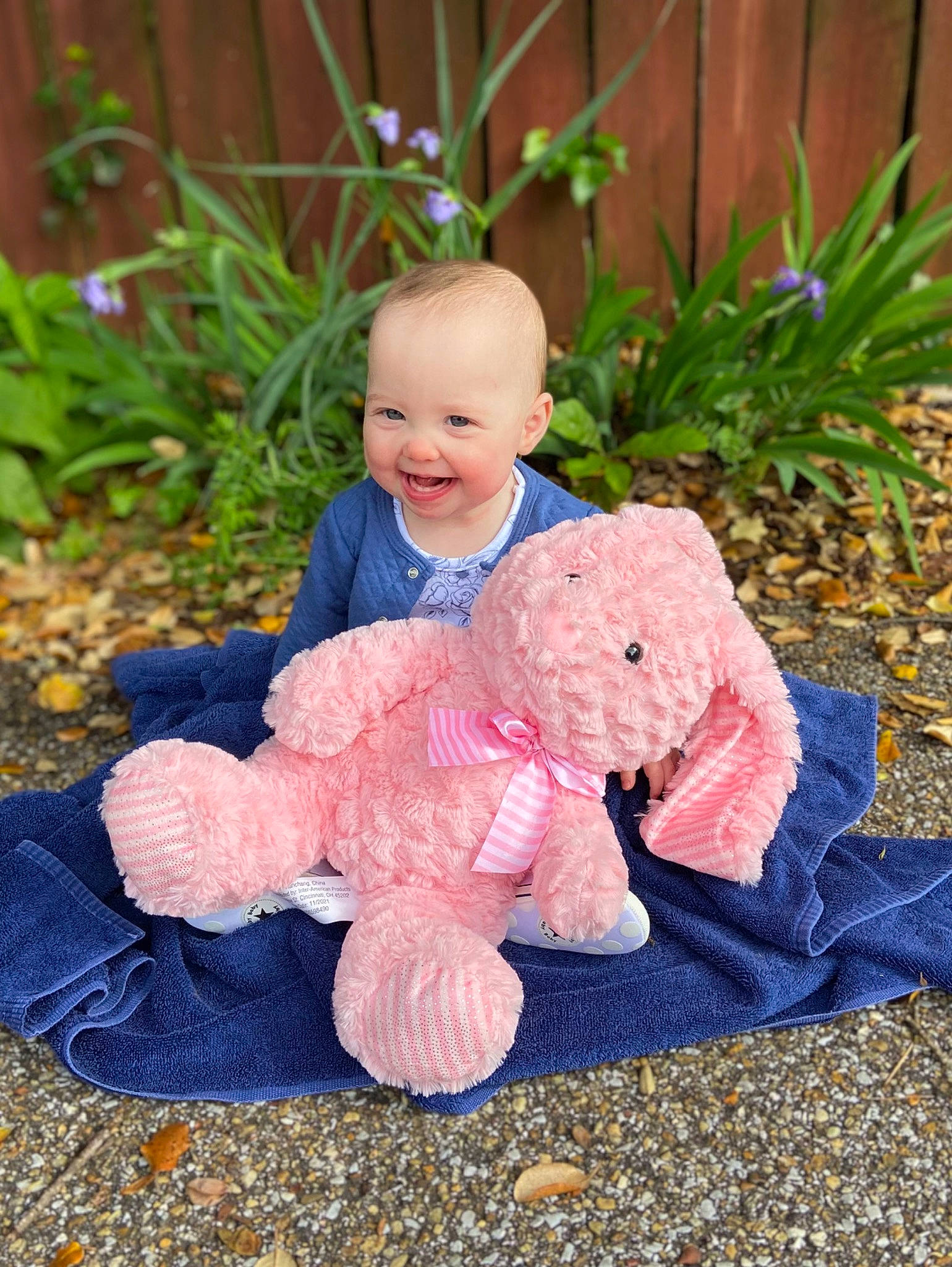 Scarlett is registered to the contest to win money with this photo: baby, baby_toddler_clothing, child, doll, dress, fur, garden, grass, happy, joy, leaf, person, plant, plush, sitting, smile, stuffed_toy, teddy_bear, toddler, toy