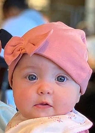 Scarlett is registered to the contest to win money with this photo: baby, baby_products, cap, cheek, child, costume_hat, eye, eyebrow, eyelash, fashion_accessory, fun, hair_accessory, happy, hat, headgear, headwear, lip, person, pink, skin