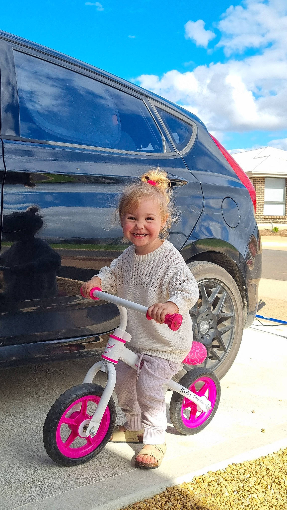 Ruby is registered to the contest to win money with this photo: automotive_design, automotive_exterior, automotive_tire, baby_toddler_clothing, bicycle_tire, blue, car, cloud, fender, happy, hood, joy, mode_of_transport, motor_vehicle, person, sky, smile, tire, travel, vehicle