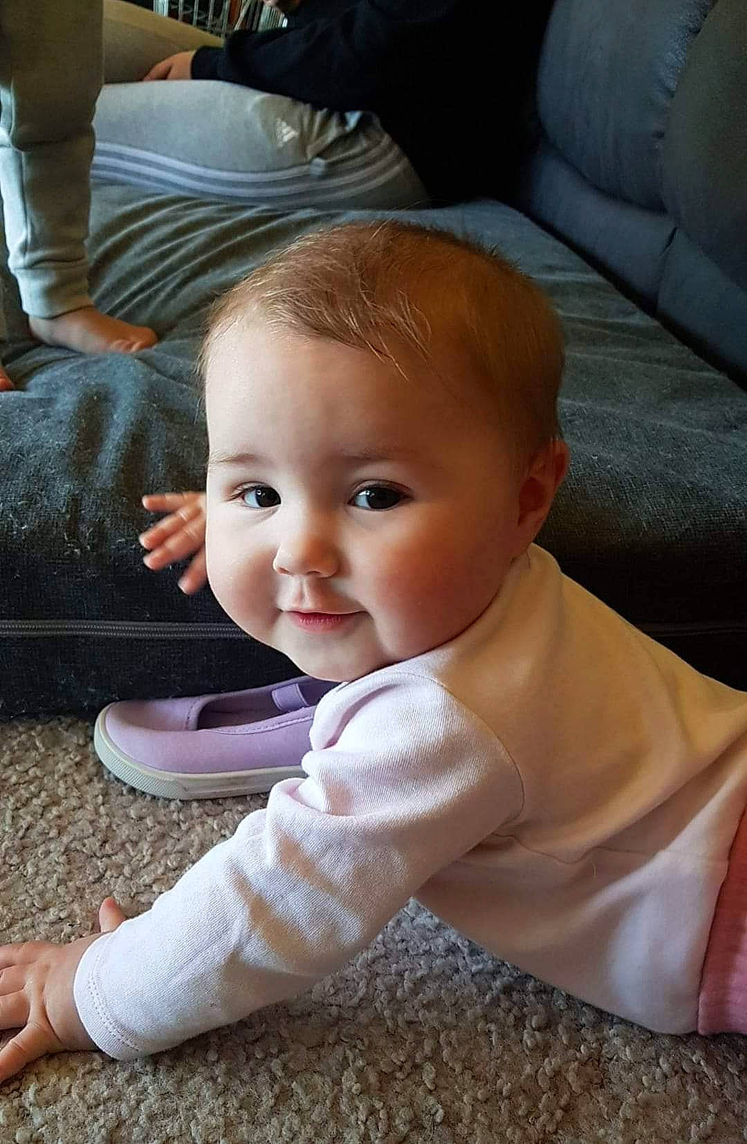 Zarli Mae is registered to the contest to win money with this photo: baby, baby_toddler_clothing, cheek, chin, comfort, couch, eye, face, floor, flooring, fun, hair, hardwood, head, iris, nose, person, skin, smile, toddler