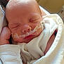 Remington is registered to the contest to win money with this photo: newborn, baby, sleeping, blanket, nasal_cannula, hospital, infant, medical, face, closeup, peaceful, wrapped, soft, child, person, healthcare, resting, cute, tape, hospital_room