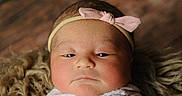 Isabella Marie is registered to the contest to win money with this photo: newborn, baby, headband, pink_bow, blanket, closeup, portrait, soft_texture, sleepy, infant, cute, cozy, wrapped, face, skin, child, young, resting, indoors, warm