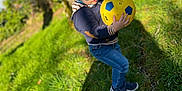 Keylan participe au concours pour gagner de l'argent avec cette photo : toddler, child, sunglasses, soccer_ball, grass, tree, sunlight, outdoor, jeans, sneakers, hoodie, nature, playing, daylight, casual_clothing, person, greenery, flower, park, cute