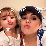 Colby is registered to the contest to win money with this photo: child, woman, selfie, filter, heart, bear_ears, indoor, pouting, face, person, love, cute, family, casual_clothing, hat, blond_hair, making_faces, holding, fun, cozy