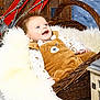 baby, infant, wicker_basket, fur_blanket, brown_overalls, bear_design, smiling, blue_eyes, rustic, wooden_skis, winter_theme, cozy, fluffy, cute, portrait, indoor, child, happy, clothing, photography
