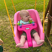 Winnie joined the competition — help win amazing prizes! baby, barefoot, child, clothing, expression, foot, grass, green, outdoor, pink, play, playground, rope, safety_strap, seat, summer, swing, toddler, toy, yellow