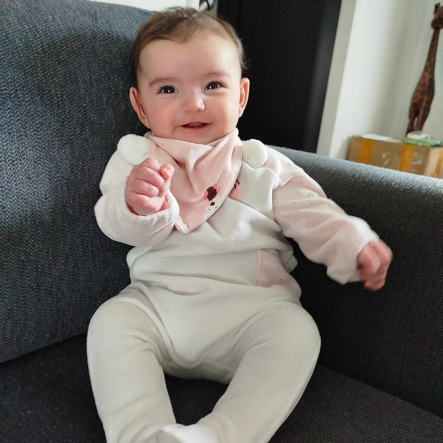 Eva participe au concours pour gagner de l'argent avec cette photo : architecture, baby, bodypart, building, clothing, couch, cushion, face, finger, furniture, hand, head, homedecor, longsleeve, pants, person, photography, portrait, sitting, sleeve