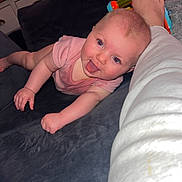 Nova joined the competition — help win amazing prizes! baby, infant, crawling, tongue_out, pink_onesie, couch, person, leg, white_pants, toy, furniture, dresser, clothes, reed_diffuser, indoor, home, playful, face, skin, happy