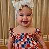 baby, child, smiling, headband, bow, dress, red, white, blue, star_pattern, sitting, indoors, face, happy, cute, person, infant, wooden_baby_gate, skin, portrait