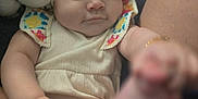 Jeannine is registered to the contest to win money with this photo: baby, infant, cute, face, hand, foot, plush_toy, soft_toy, fabric, clothing, portrait, closeup, child, skin, person, indoors, comfort, cute_expression, texture, relaxation
